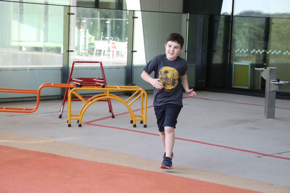 Boy comes running towards the camera

